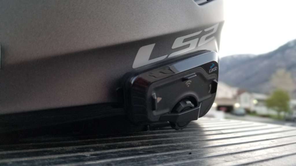 The Cardo 4+ headset, pictured from the front in extreme close-up. 