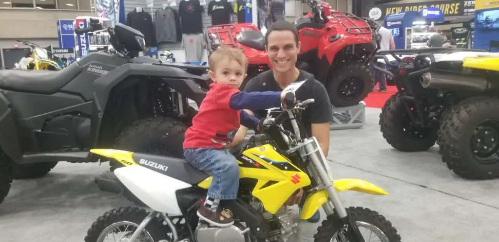 Father and son pose with the Suzuki DR-Z50.