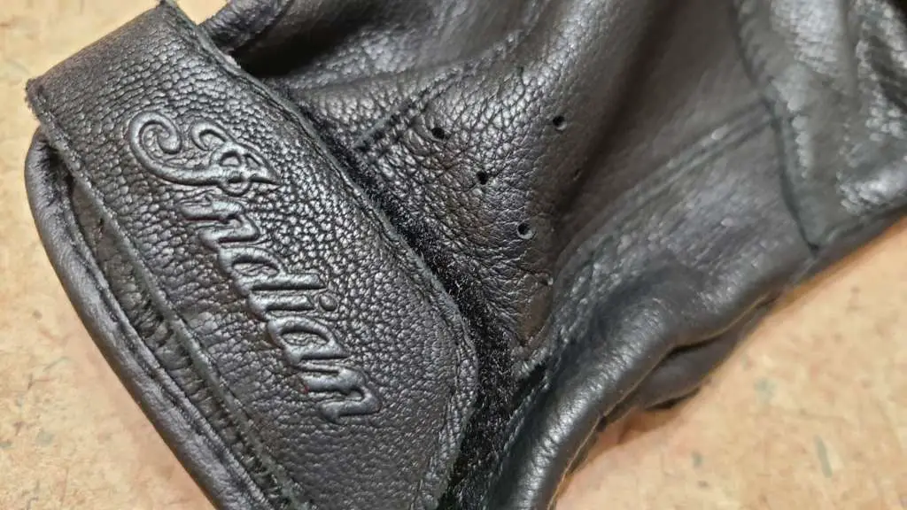 An Indian Summer Ep7 - Luxurious Leather Extreme close-up of the Indian logo on the Classic Women's Riding Glove.