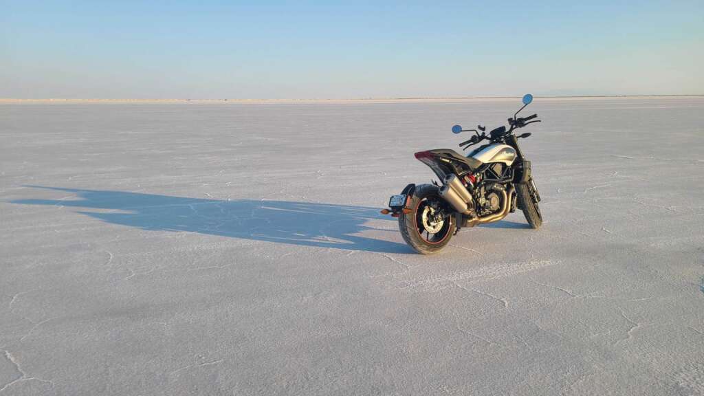 Dramatic shot of the Indian FTR-S standing in the middle distance, the wide expanse of flat, featureless salt flats stretching out to the horizon.